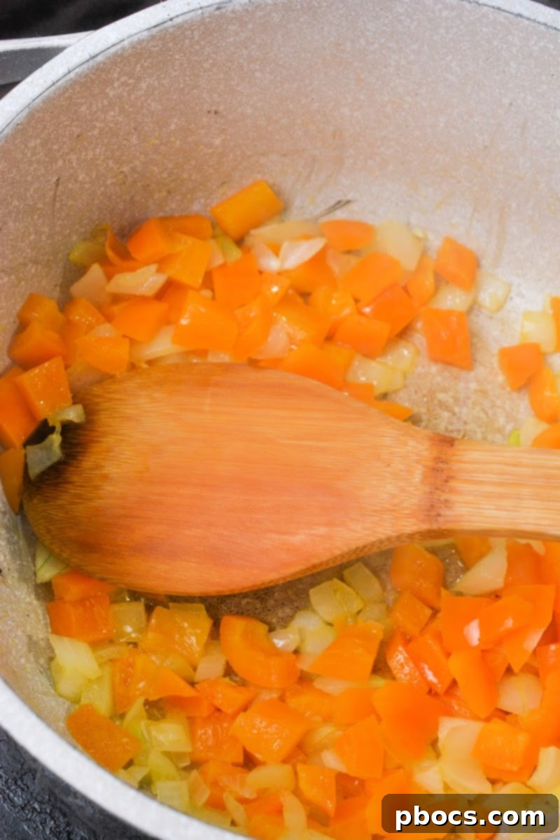 Low-Carb Italian Zucchini Bliss 8 Sauteeing onions and bell peppers in a pot for the soup base.