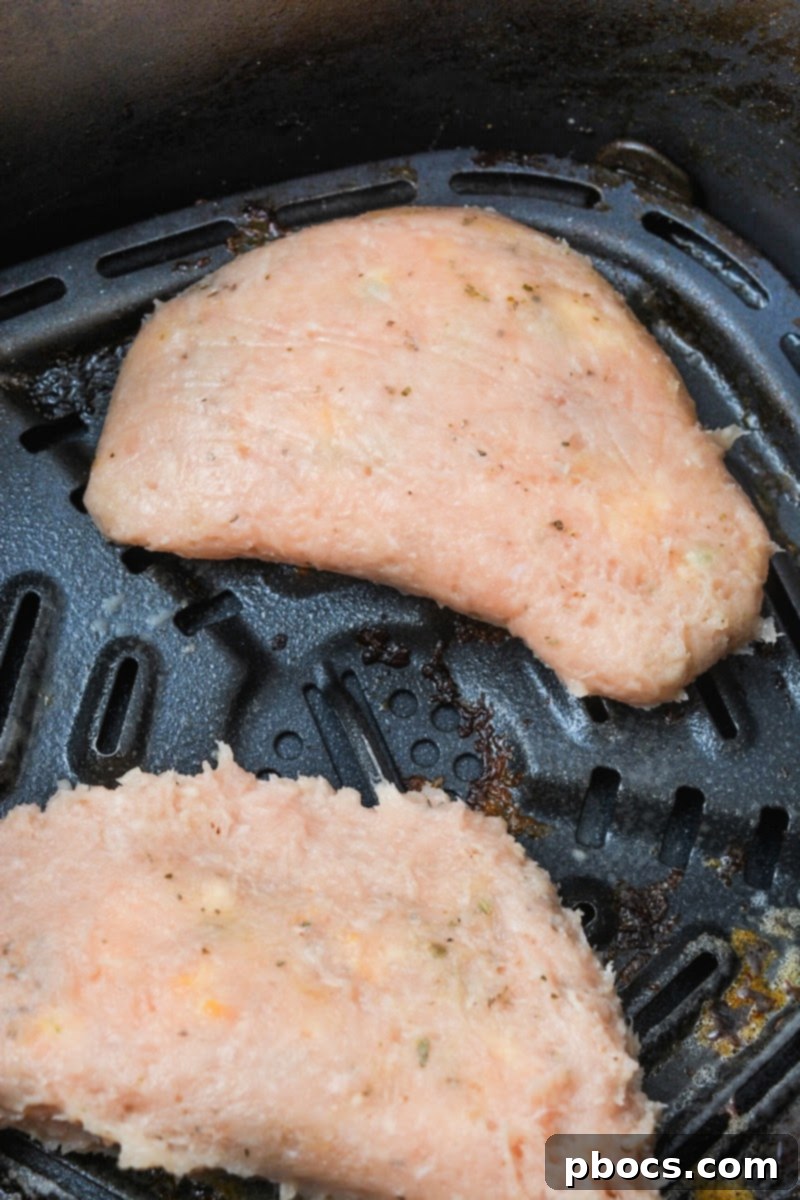 Keto Cheesy Ranch Chicken Pockets 13 Placing the Keto Crack Chicken Hot Pockets into the air fryer basket for cooking