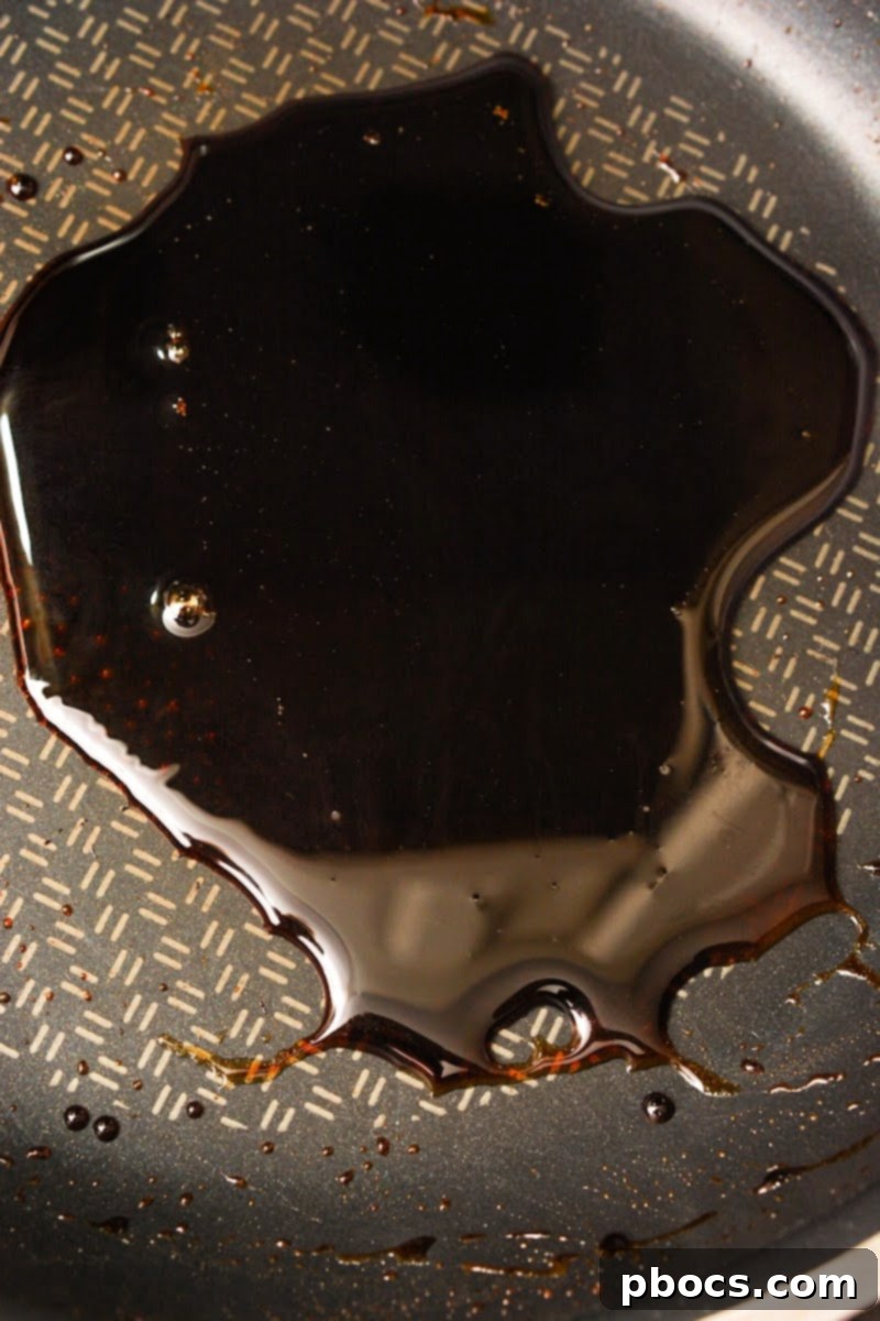 Making the keto balsamic glaze in a small skillet