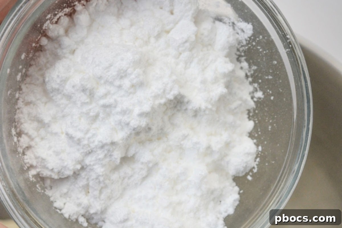 Keto Cookies and Cream Dream 10 Cream cheese and powdered sugar substitute in a mixing bowl