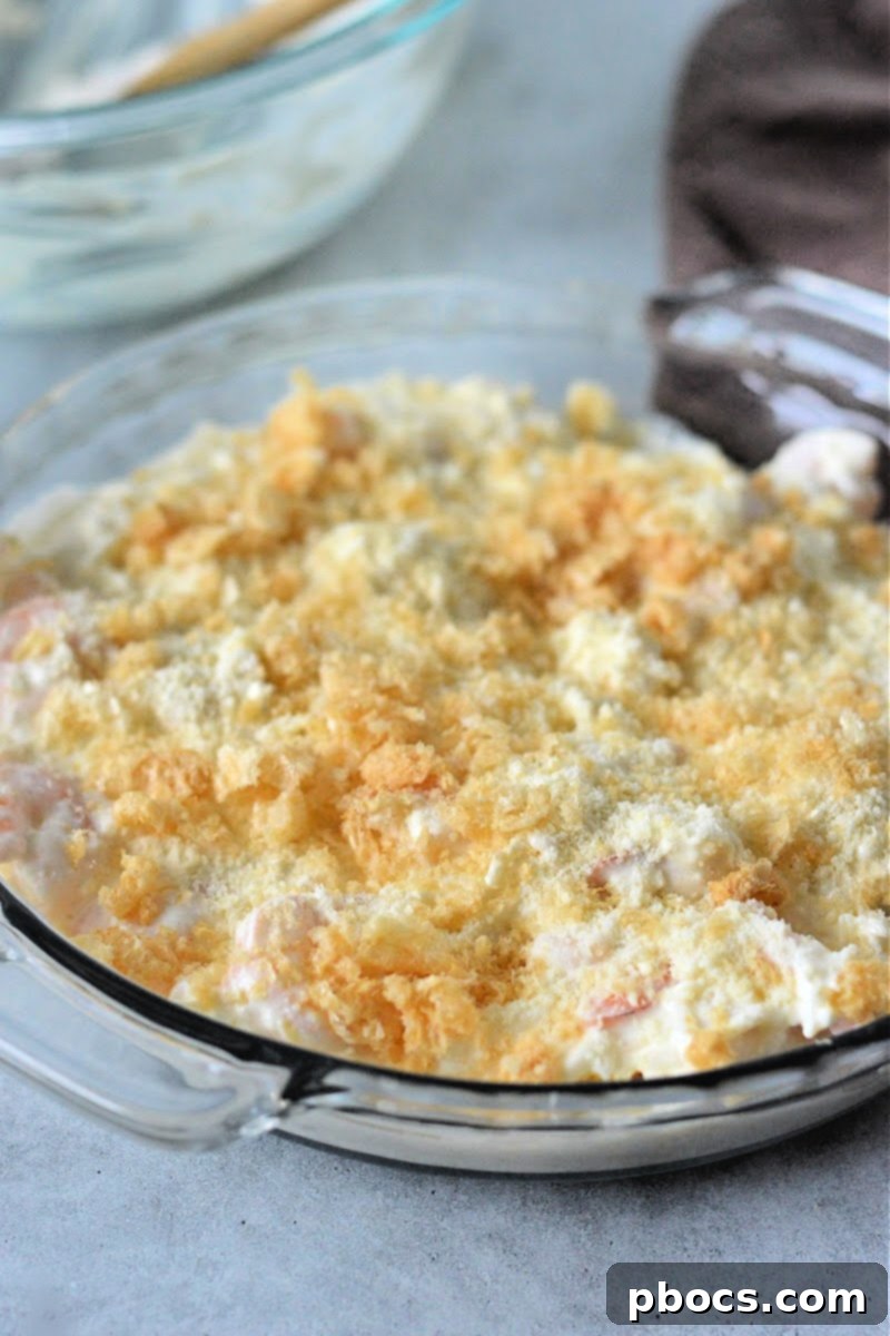 Keto Shrimp Scampi Dip mixture spread into a baking dish