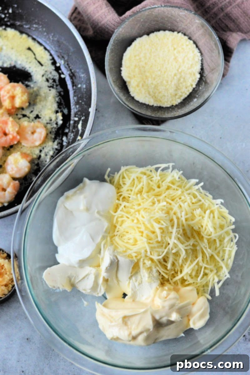 Ingredients for the cheesy dip being added to a mixing bowl