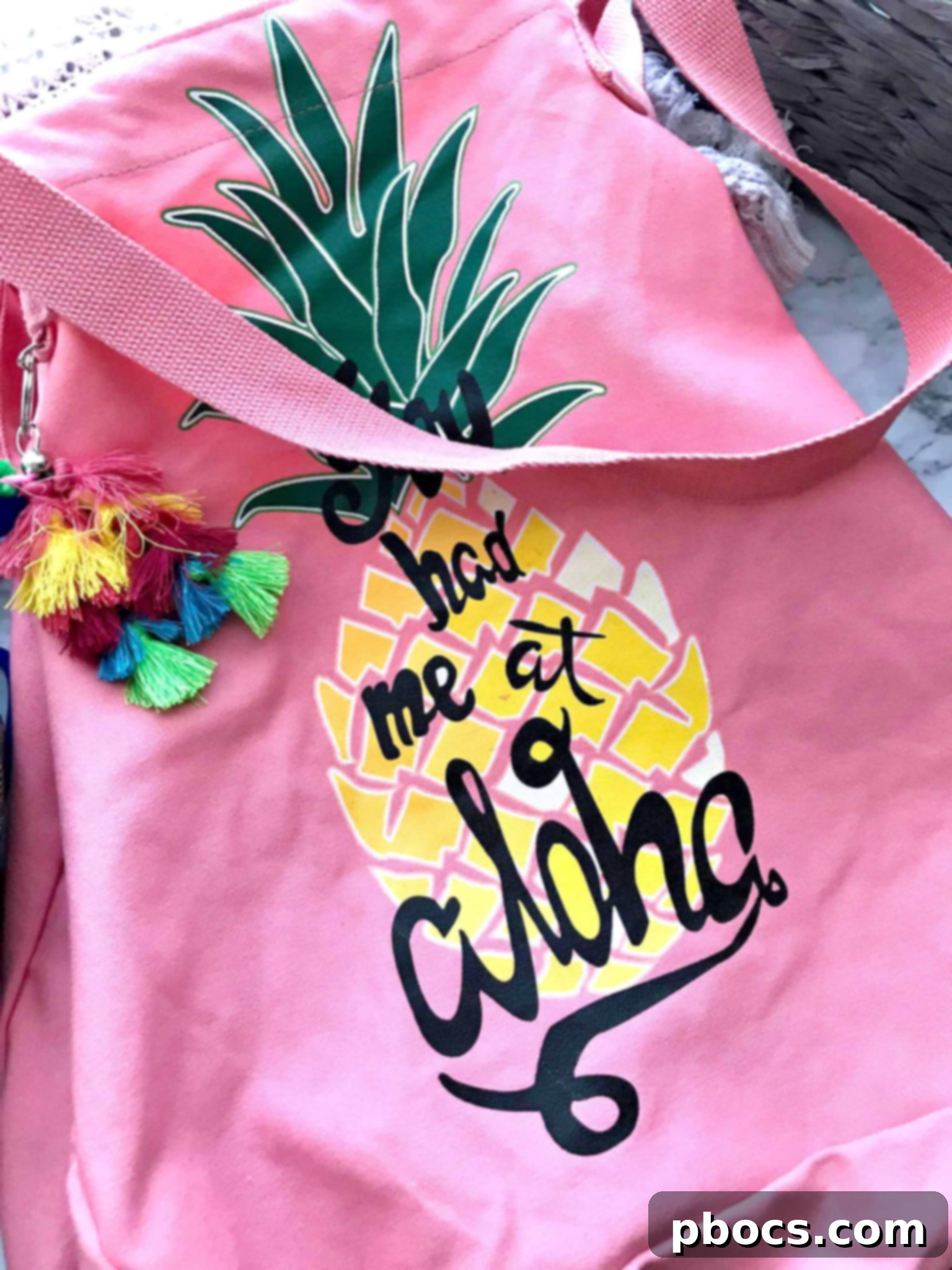 A close-up view of essential items in a beach bag, highlighting Tom's of Maine deodorant and stylish accessories