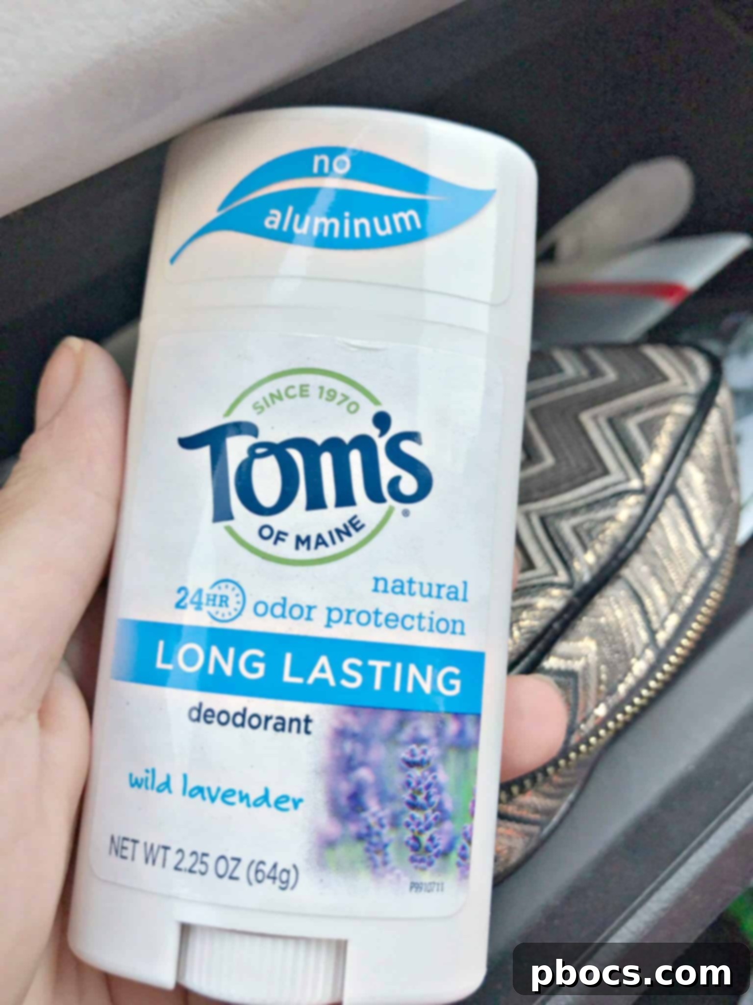 Tom's of Maine Long Lasting Deodorant bottle positioned attractively amidst beach-themed accessories