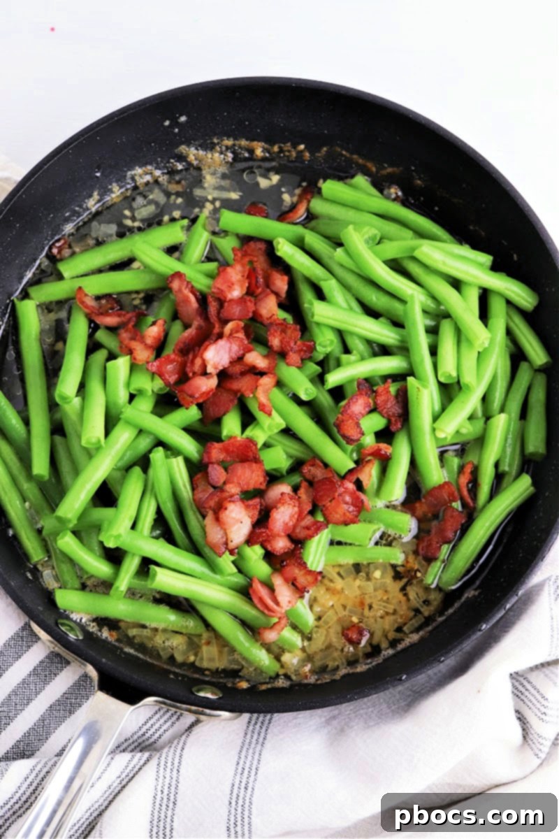 Adding bacon to the green beans in the skillet