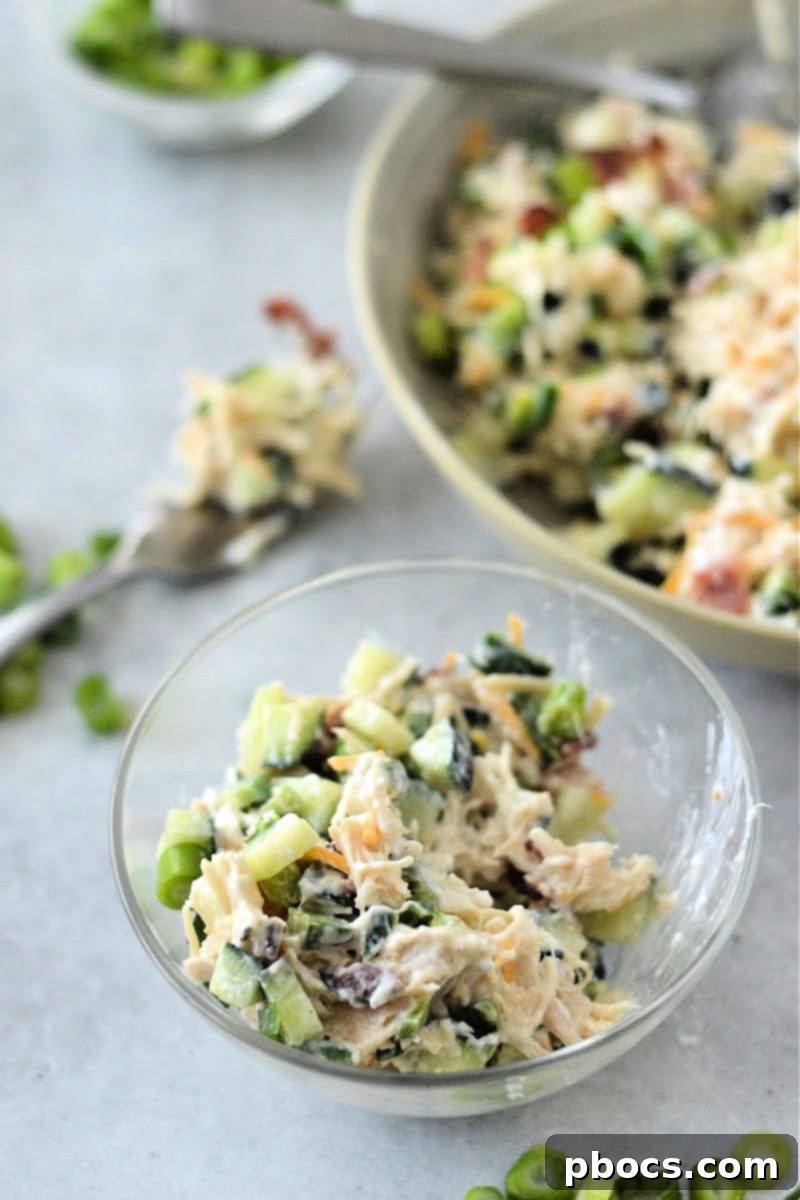 Mixing ingredients for Keto Jalapeno Popper Chicken Cucumber Salad