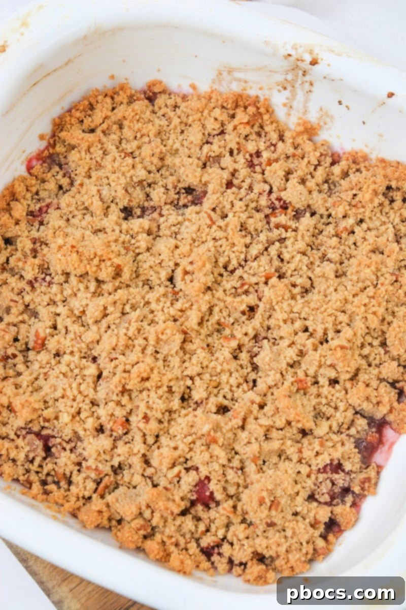 Baked Low Carb Raspberry Crumble showing a golden topping