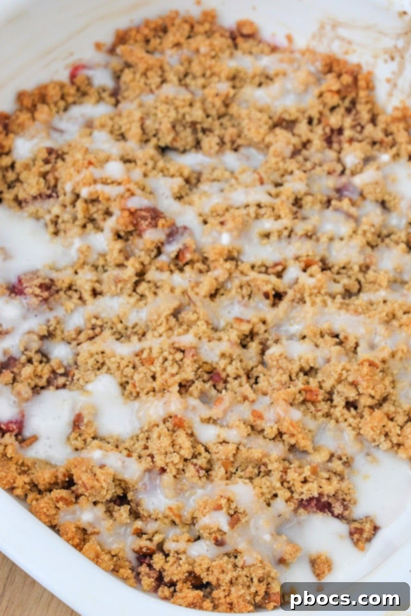 Hands preparing the Low Carb Raspberry Crumble mixture