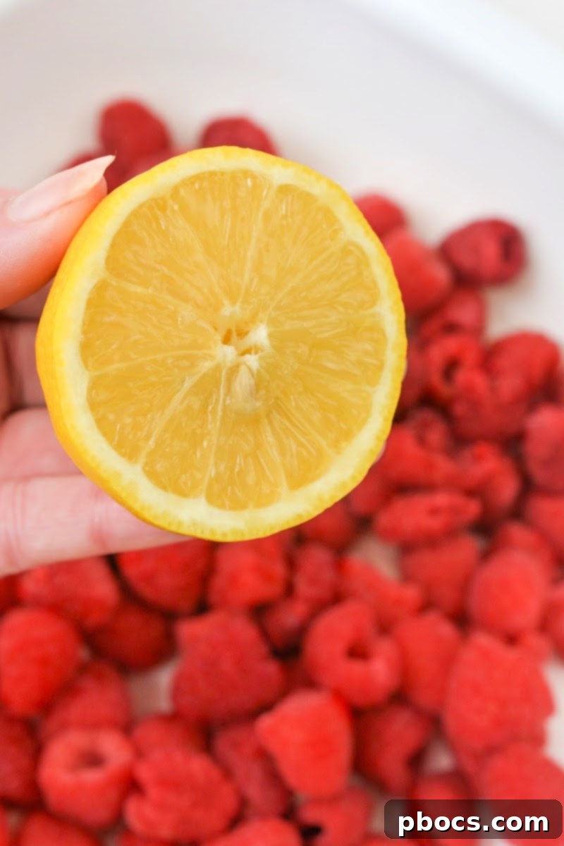 Half a lemon and raspberries