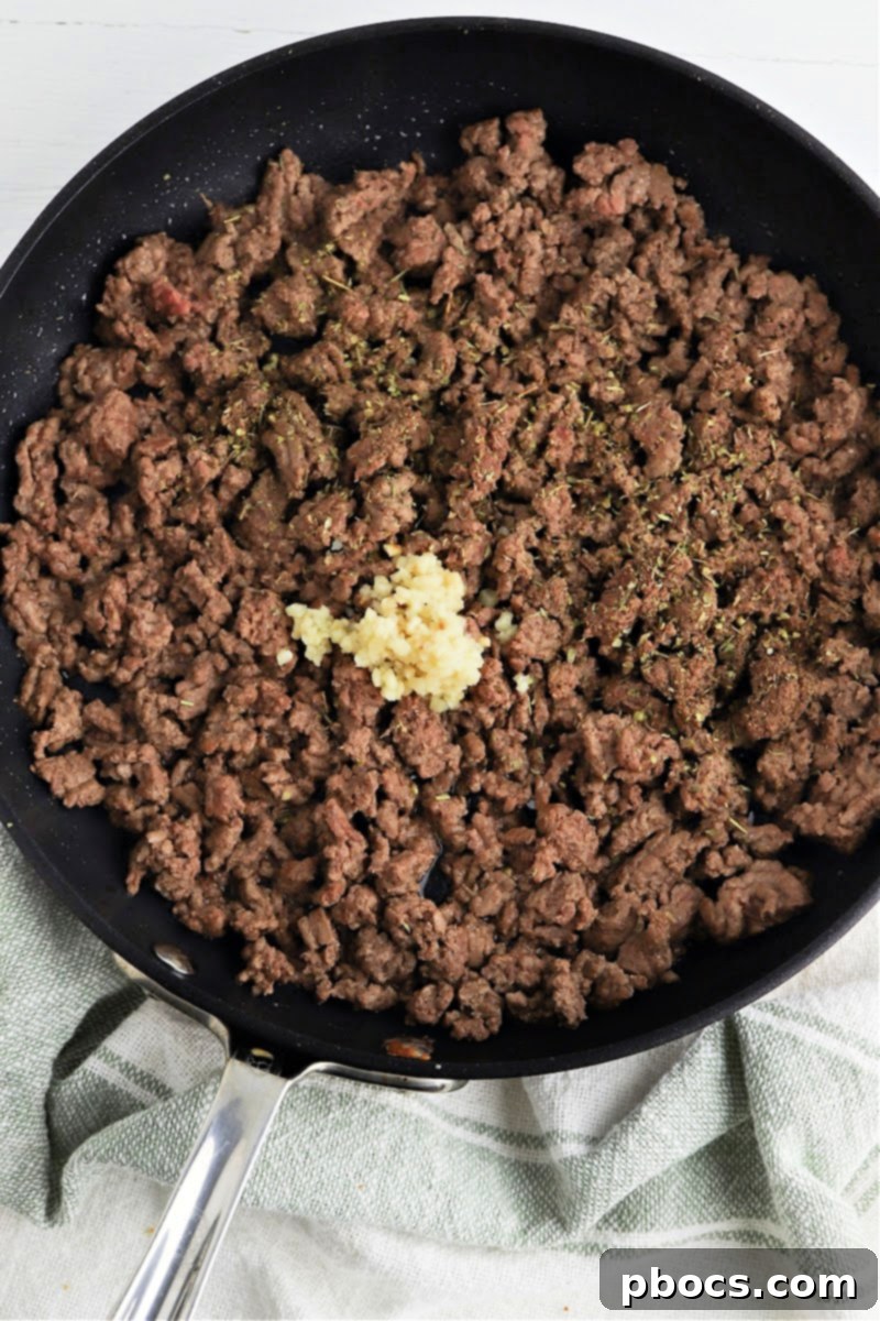 Sautéing ground beef with garlic and spices
