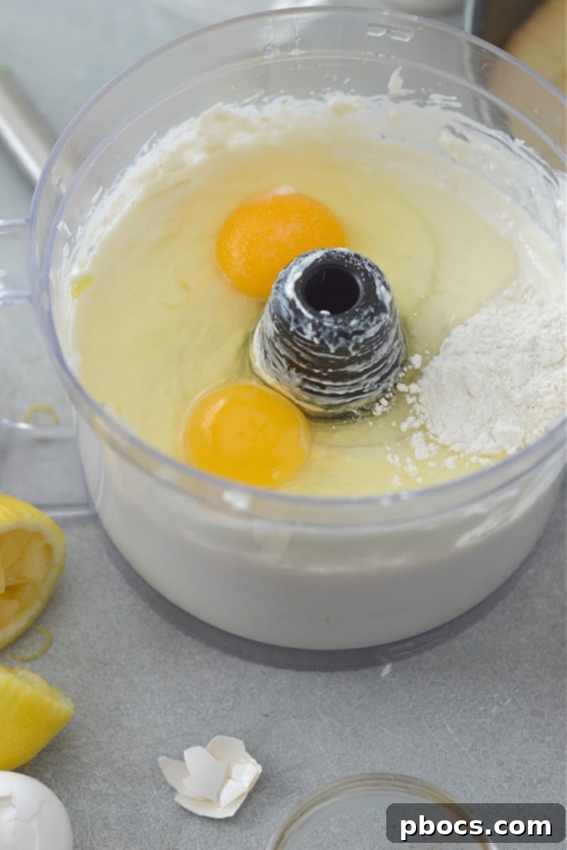 Adding eggs to the cheesecake filling