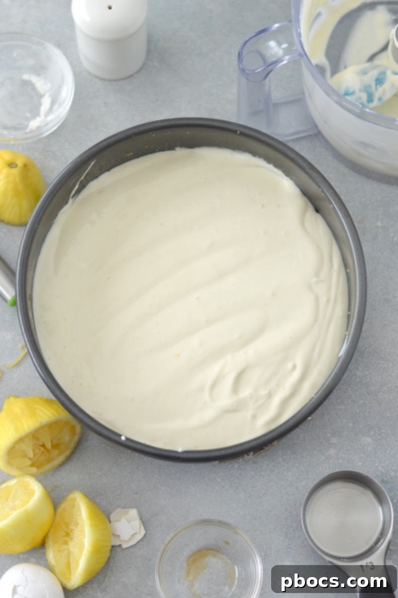 Adding cheesecake filling to the pan