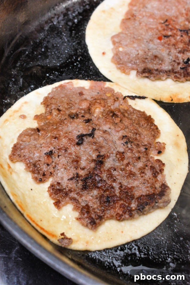Keto Morning Smash Burger Bites 10 Frying sausage on the tortilla