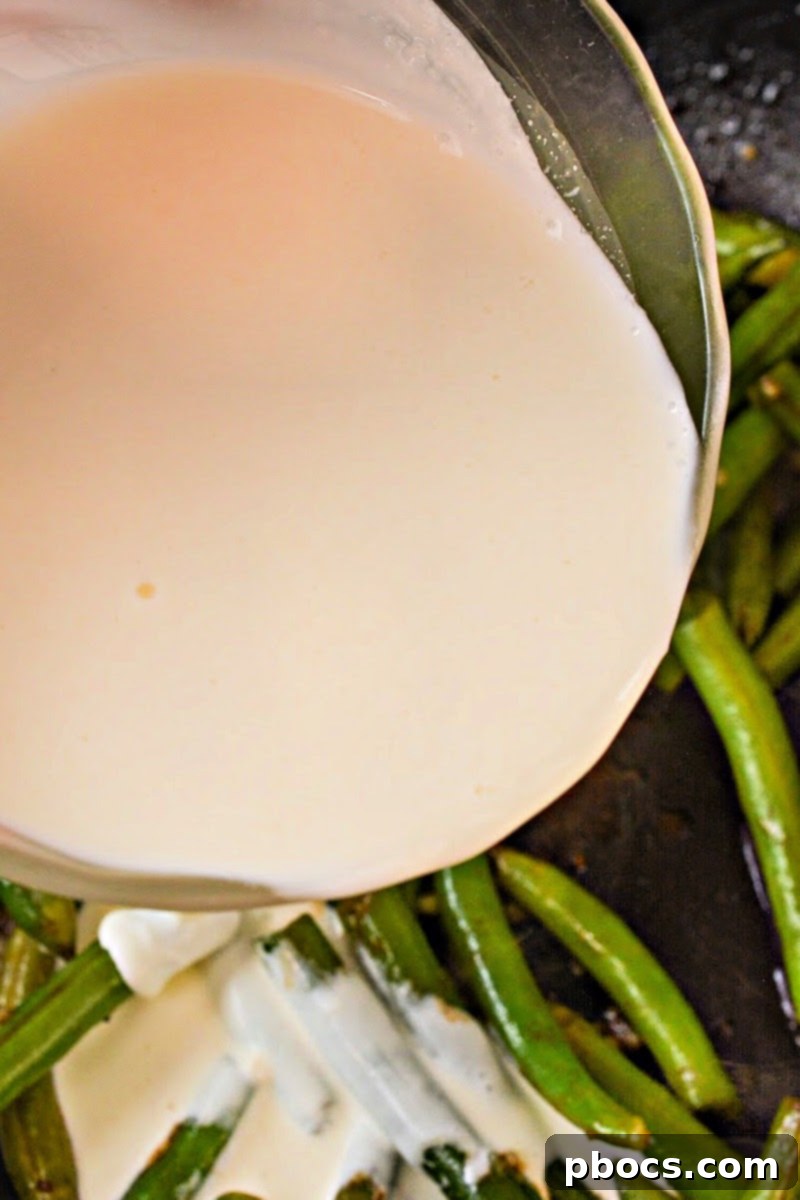 Pouring cream onto the green beans
