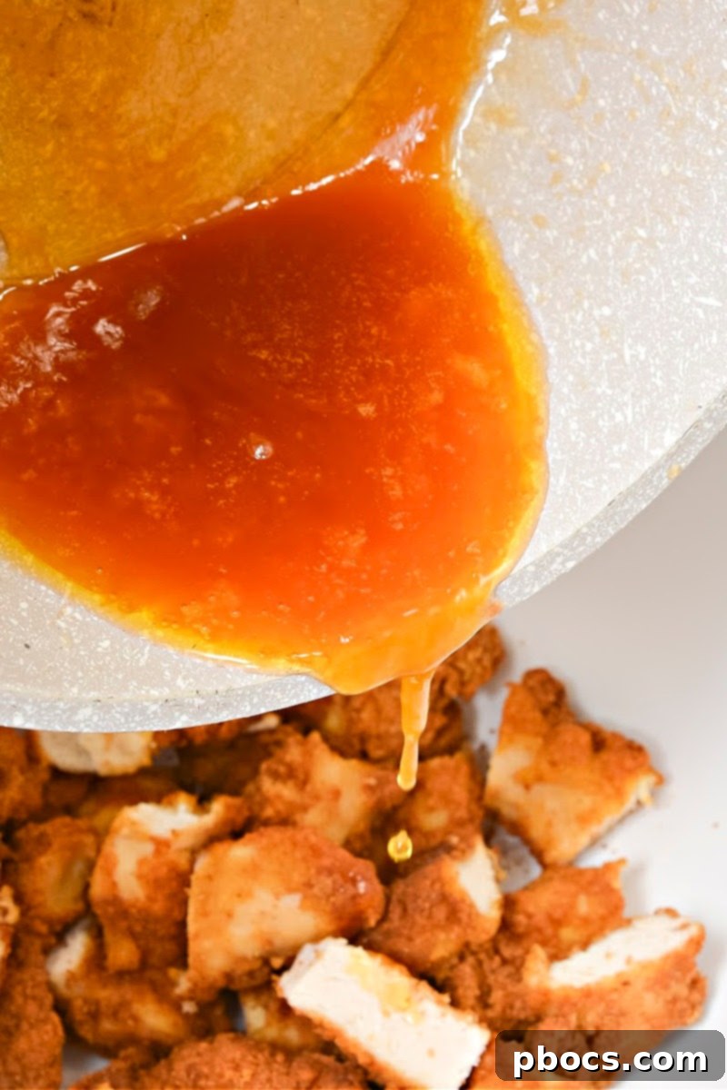 Adding hot honey to the chicken