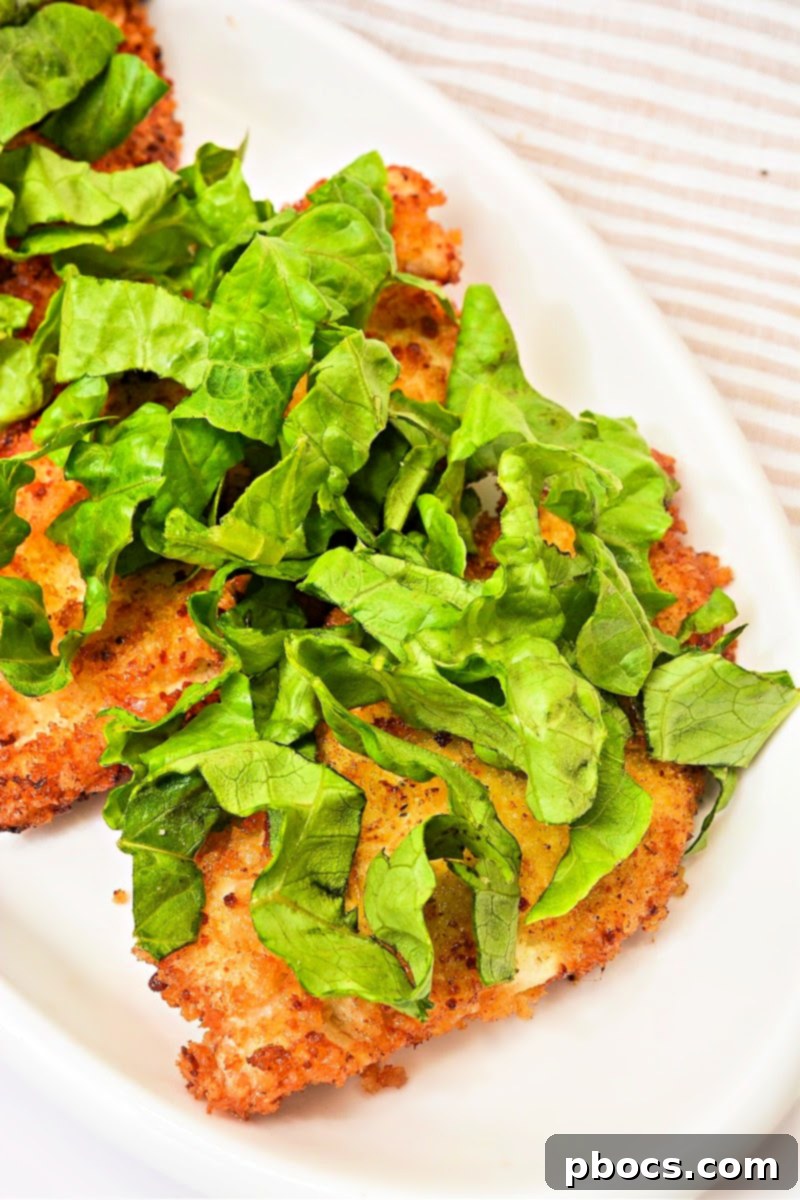 Adding shredded romaine lettuce to keto chicken cutlets