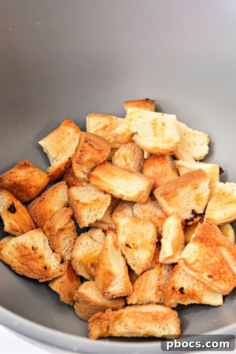 Keto bread being cut into cubes for croutons