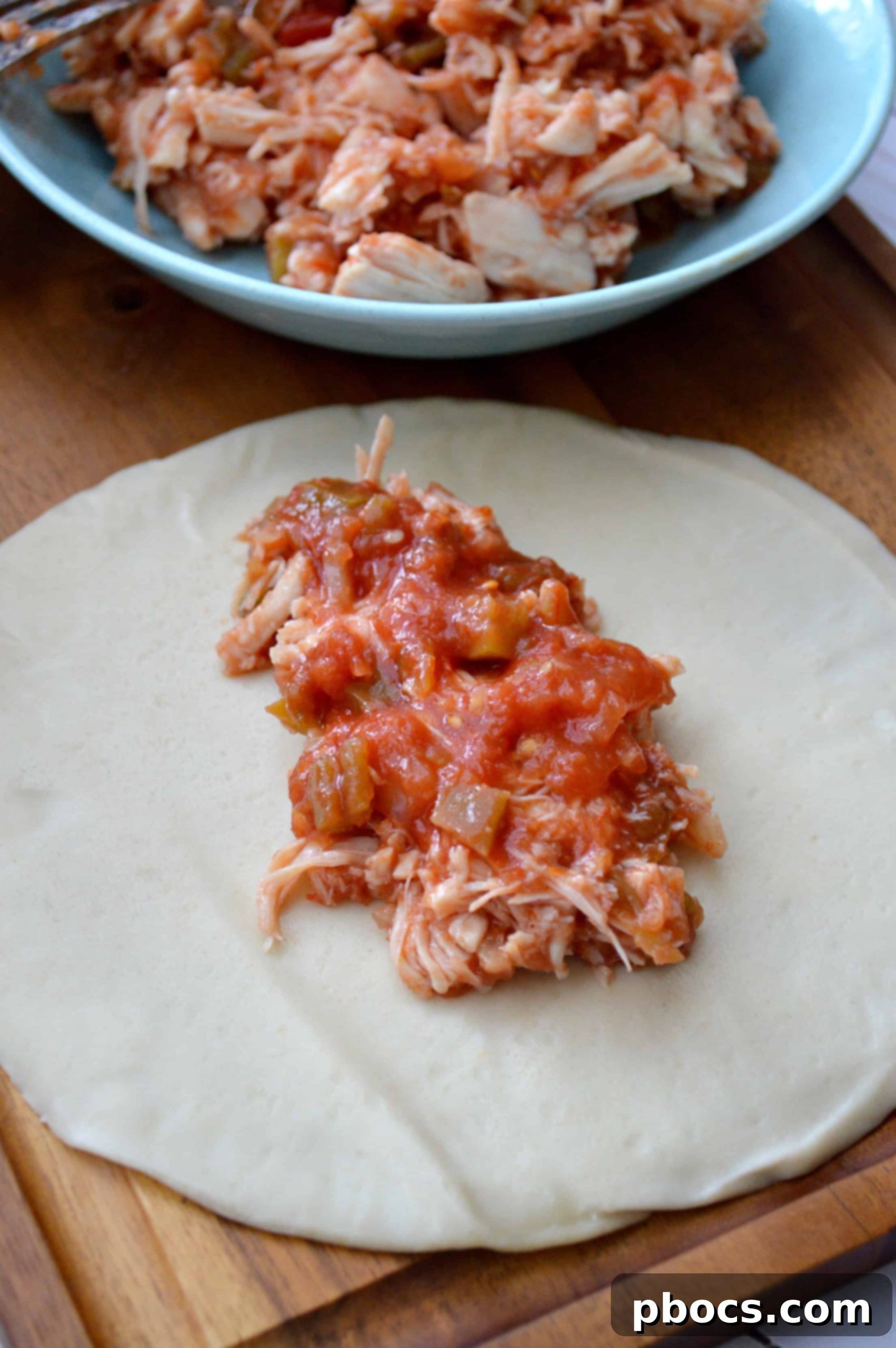 Filling and folding empanada dough