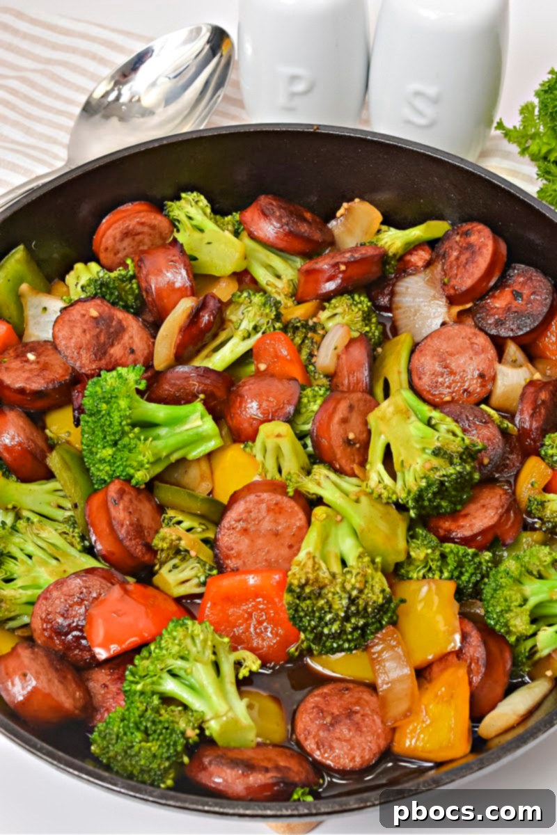 Finished Low Carb Asian Sweet and Sour Kielbasa in a skillet, coated in sauce and ready to serve