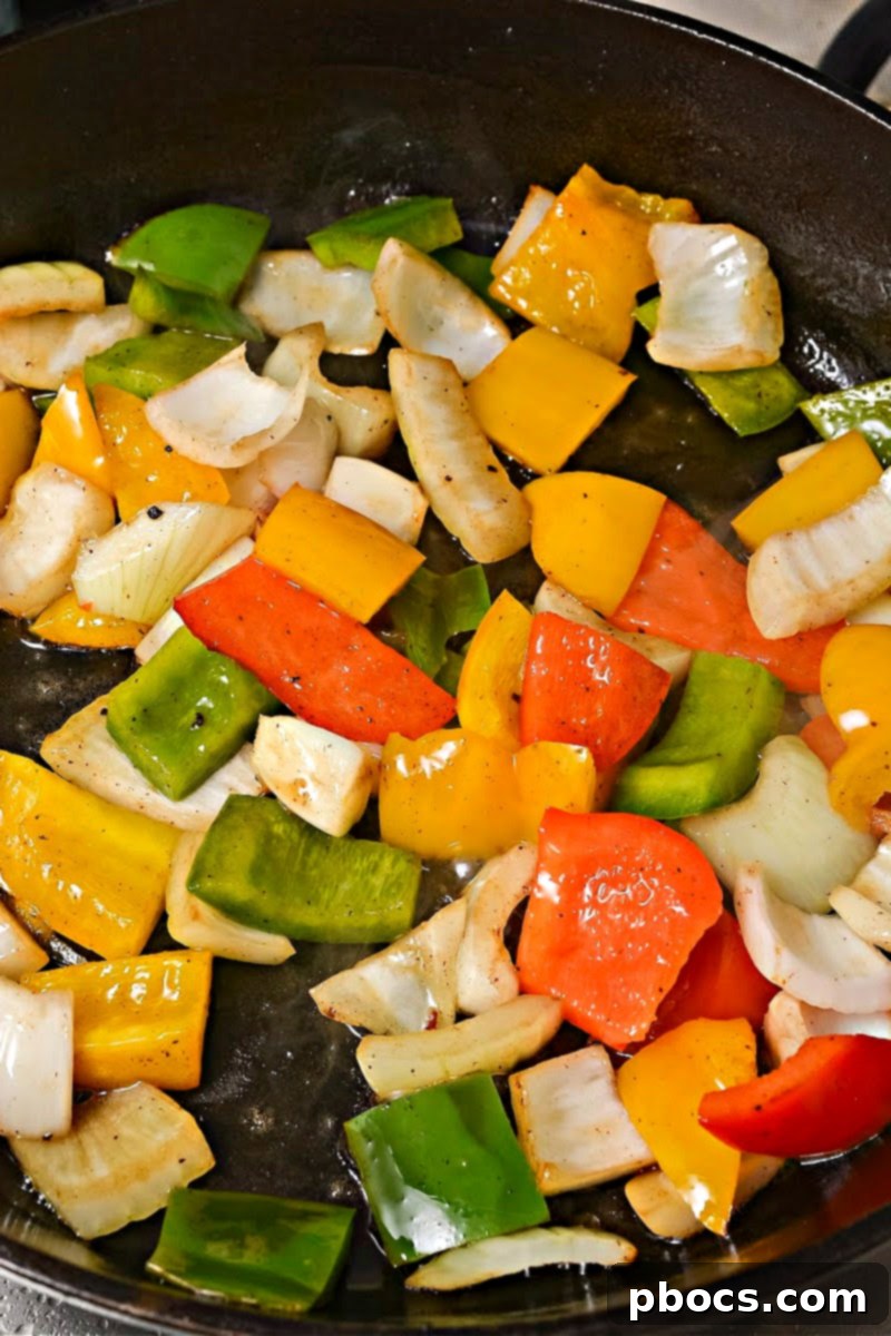 Sautéing a colorful mix of bell peppers and onions in a hot skillet