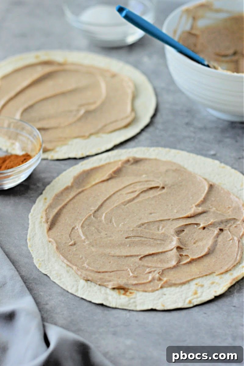 Keto Cinnamon Cream Cheese Delights 9 Spreading cream cheese mixture on a tortilla