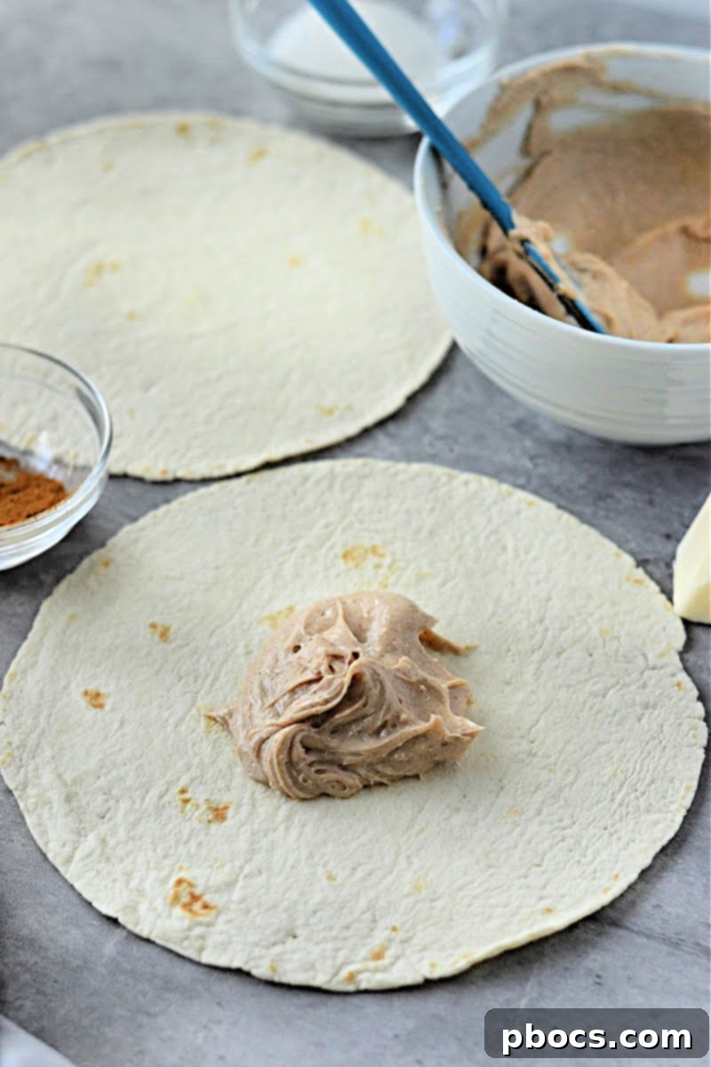 Keto Cinnamon Cream Cheese Delights 10 Tightly rolling the tortilla with filling