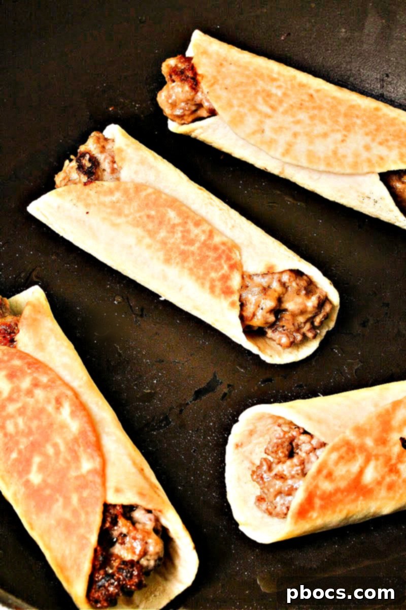 Keto Beef & Cheese Spirals 12 Cooking assembled Keto Cheesy Beef Roll Ups in a skillet until golden and crispy