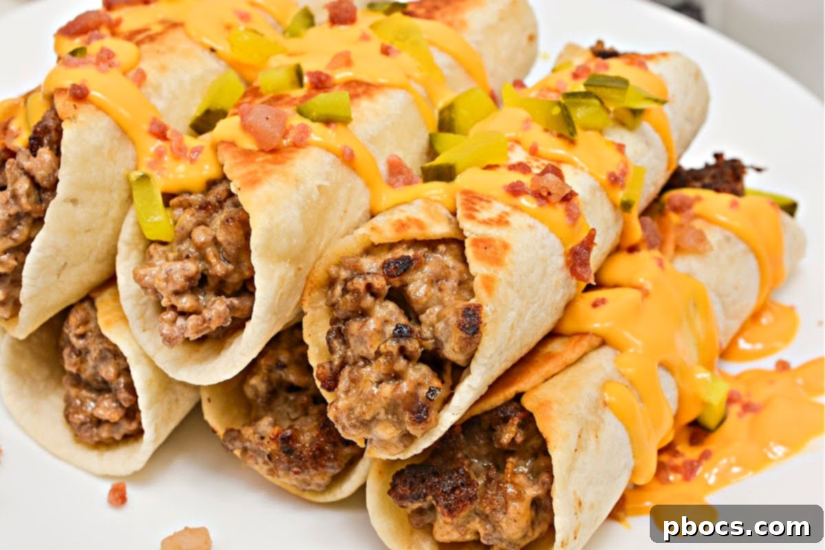 Keto Beef & Cheese Spirals 13 Finished Keto Cheesy Beef Roll Ups garnished with crunchy pickles, savory bacon, and a drizzle of rich cheese sauce