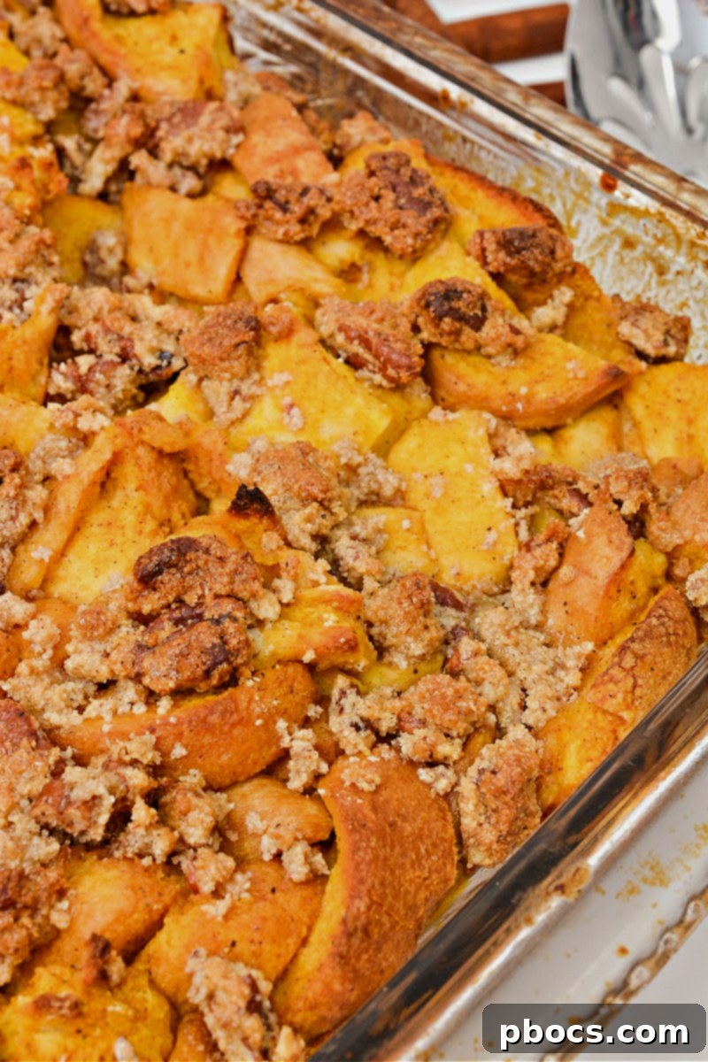 Sprinkling pecan topping over Keto Pumpkin French Toast Bake