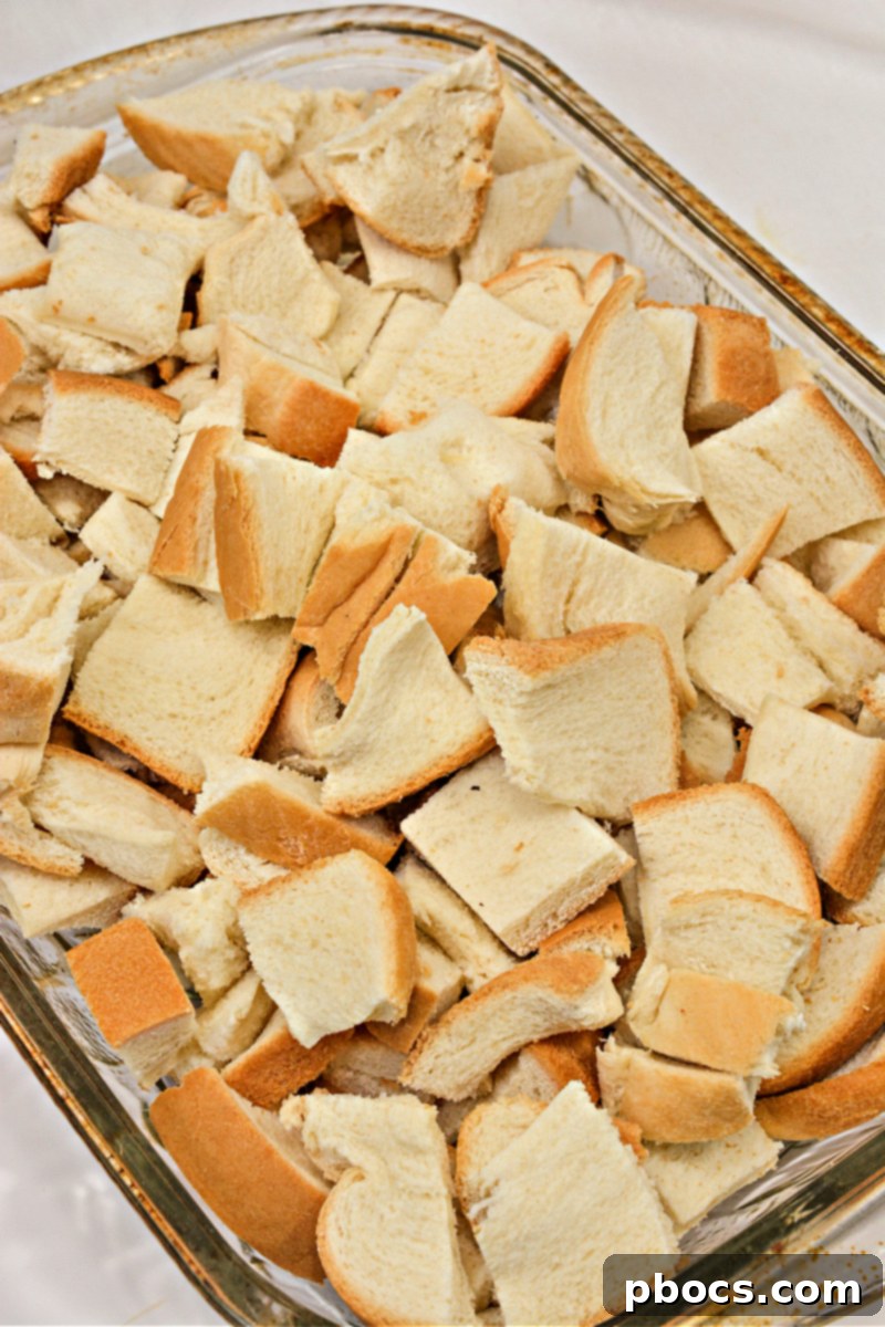 Keto bread cubes layered in a baking dish