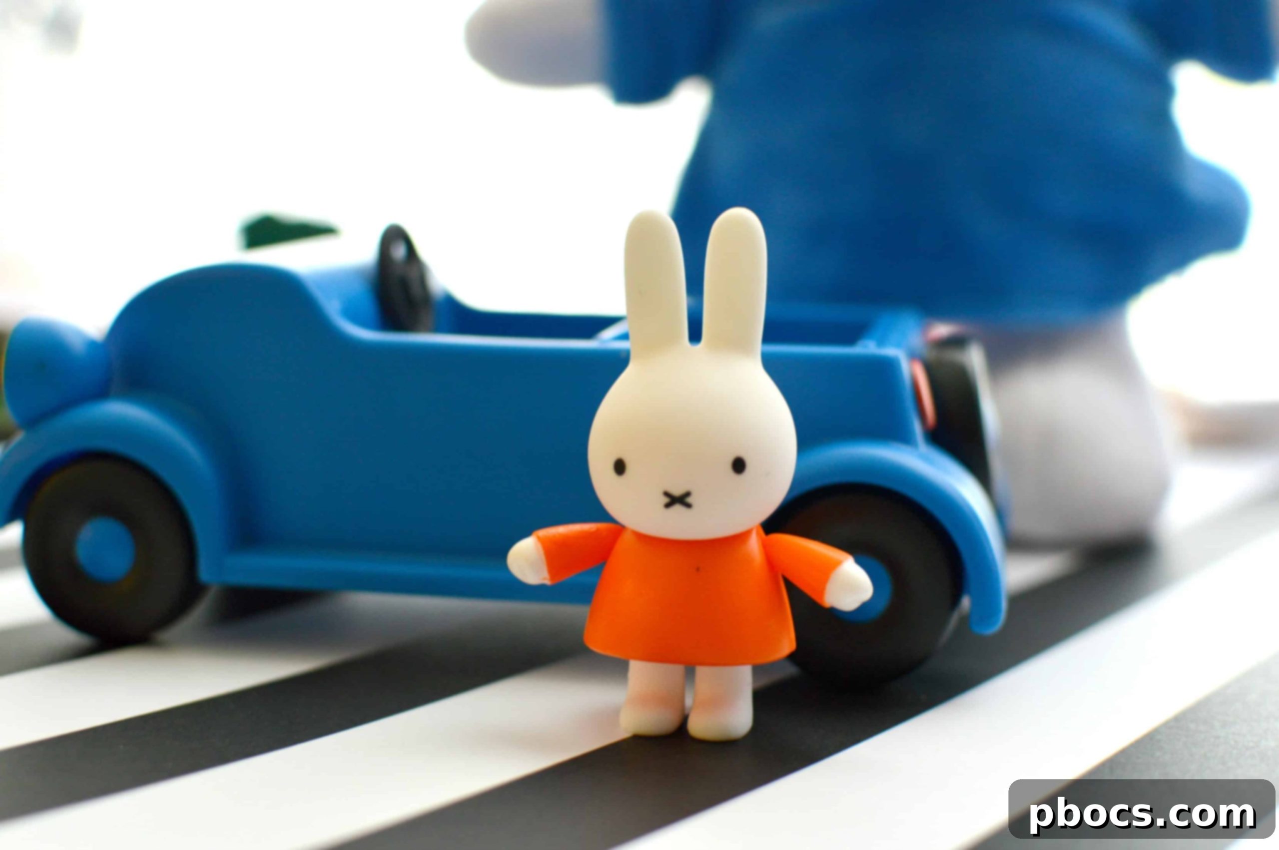 Two Miffy plush toys and a Miffy-themed book