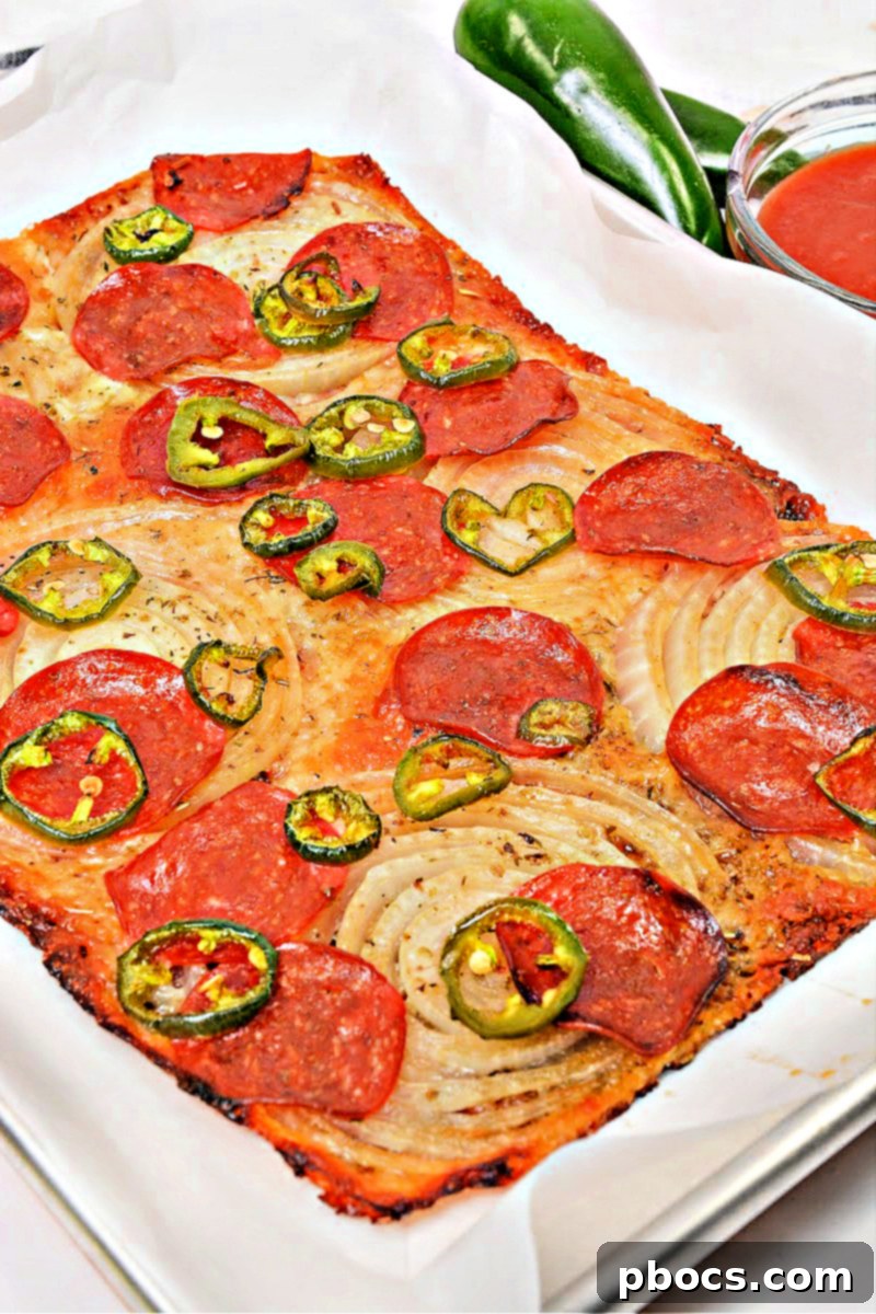 Adding toppings to the Keto Viral Onion Ring Pizza