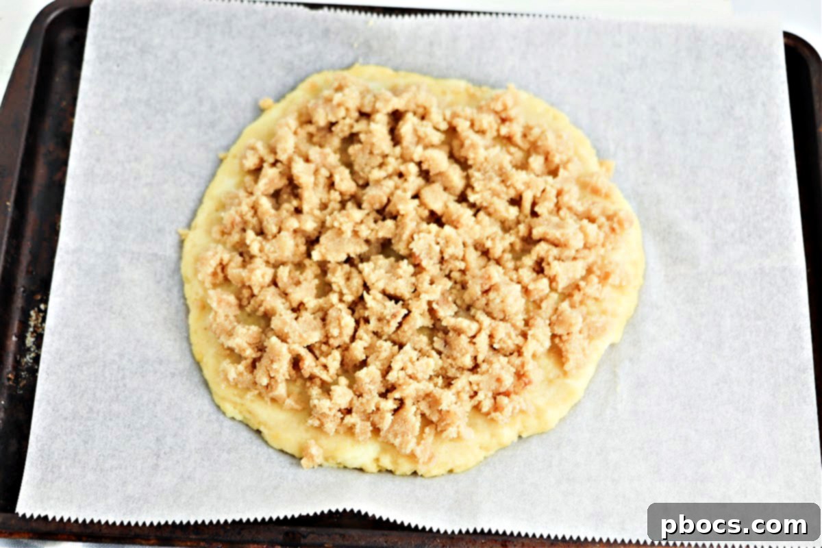 Keto dessert pizza with topping before baking.