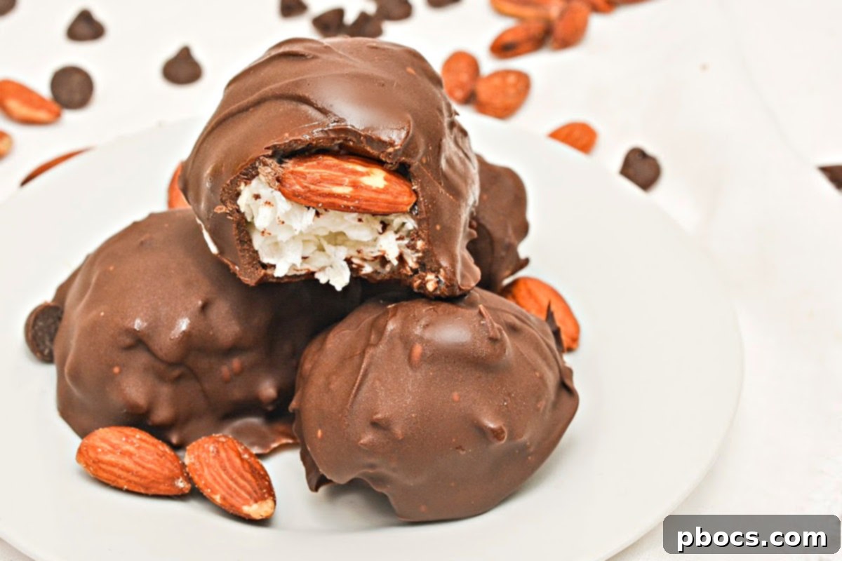 Keto Coco-Almond Bliss Bites 6 A Keto Almond Joy Cluster being carefully dipped into a bowl of melted keto chocolate