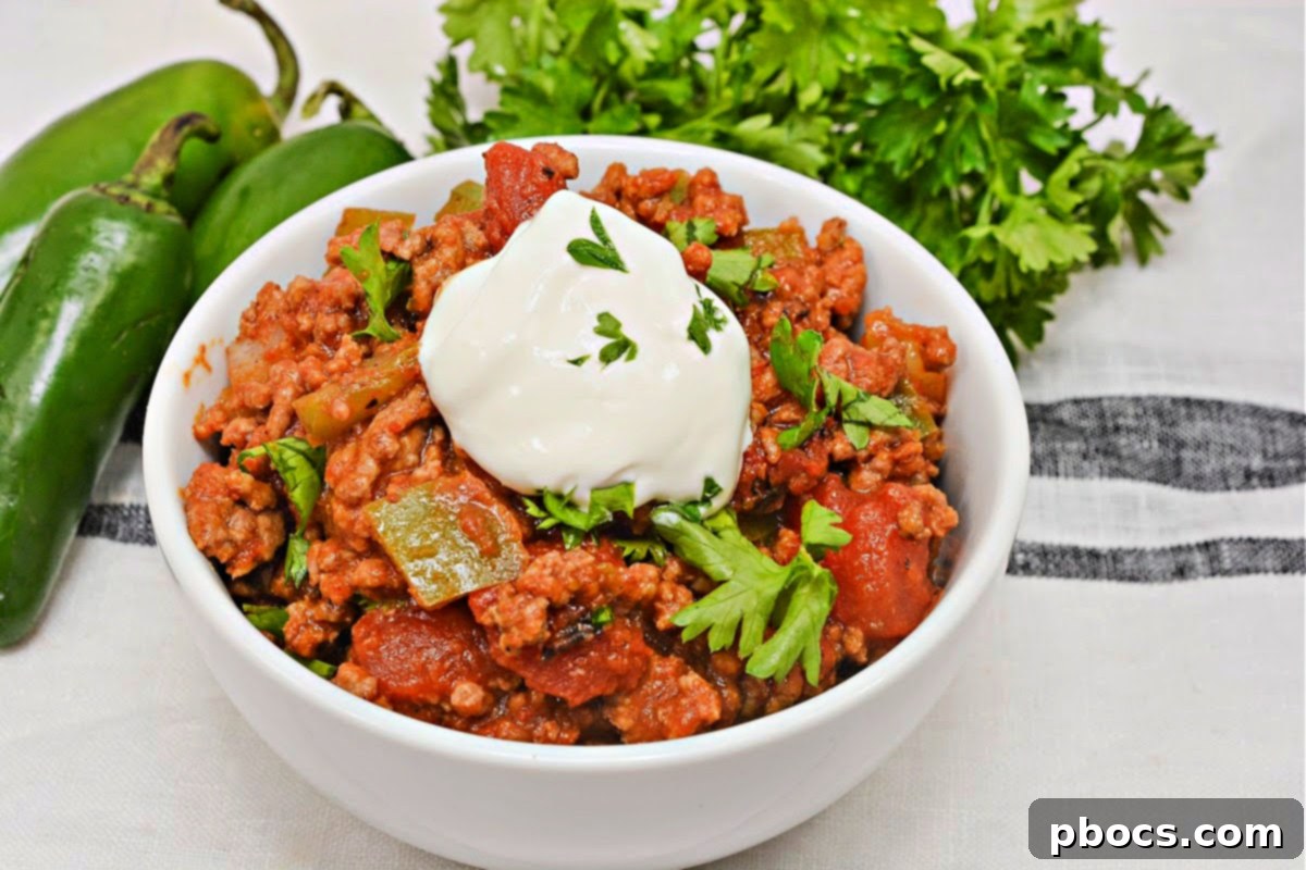 Low Carb Pumpkin Chili Sloppy Joe Skillet with a spoon