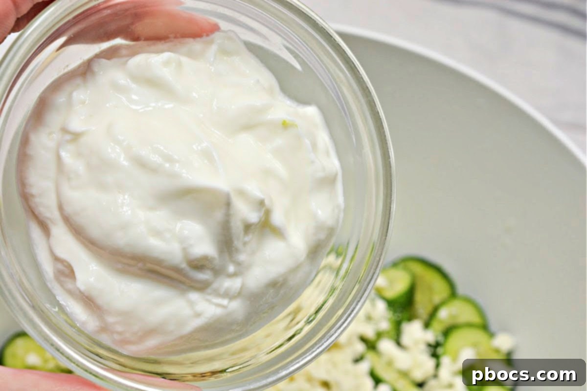 Mixing ingredients for Low Carb Broccoli Cucumber Salad