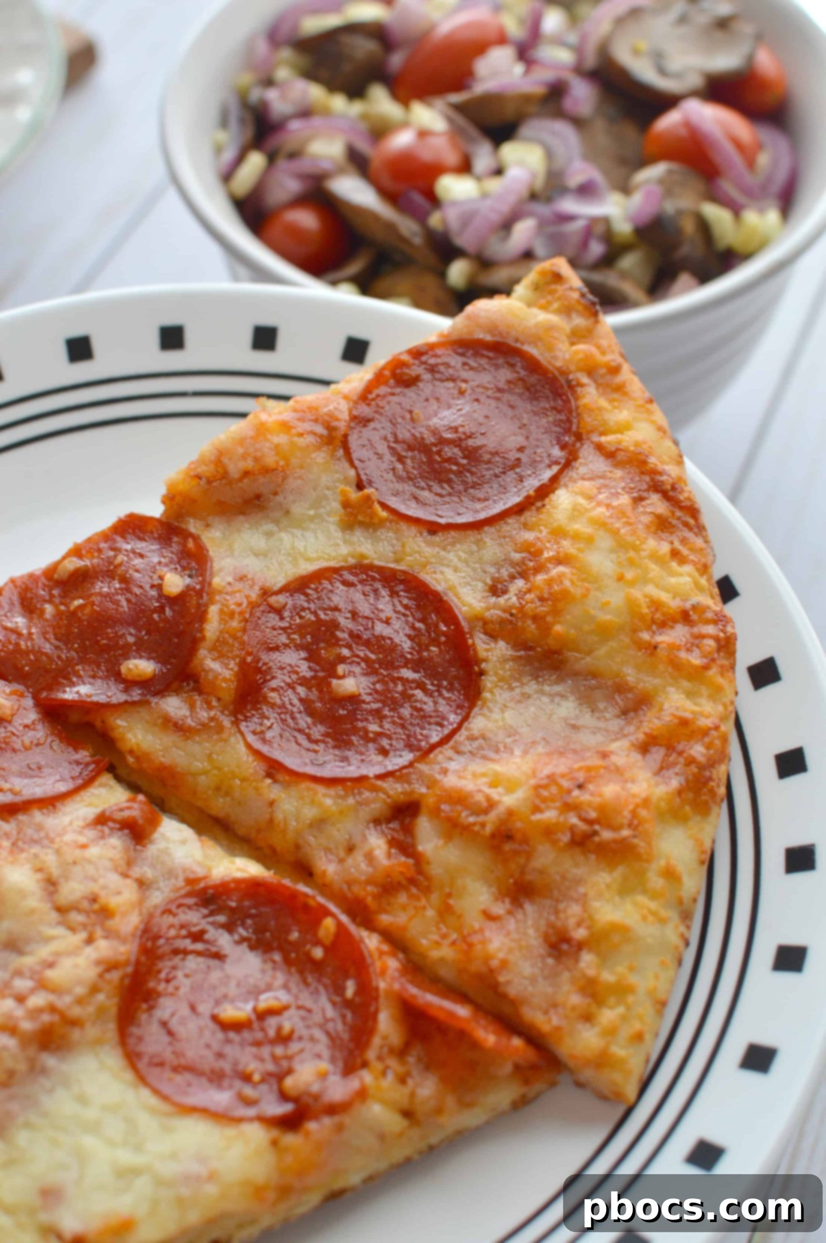 Effortless Efficiency Getting Things Done with an Easy Mushroom Corn Salad 5 Close-up of a delicious slice of Red Baron pizza paired with a fresh mushroom and corn salad, a perfect family meal.