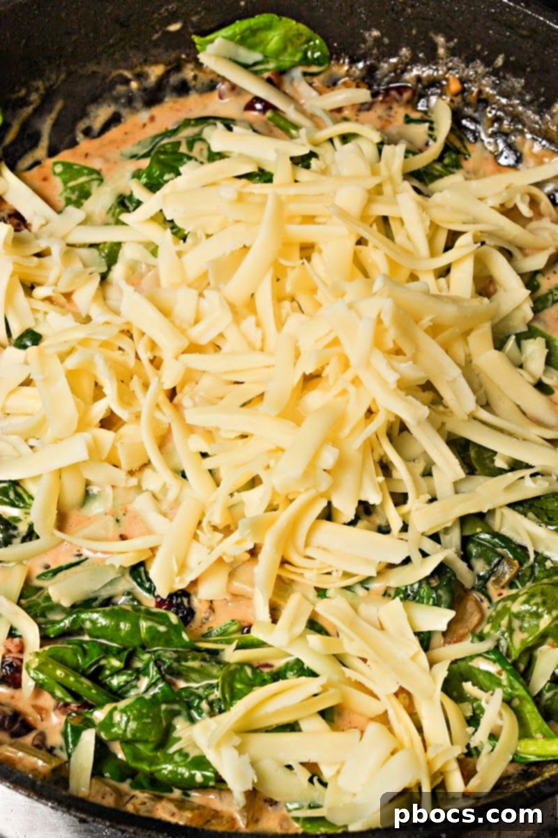 Step 4: Melting white cheddar cheese into the sauce