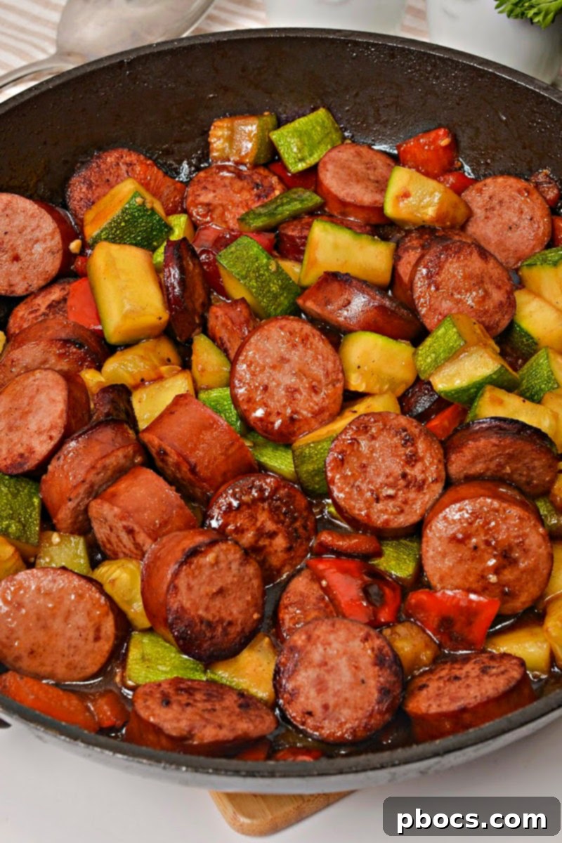 Pouring Kung Pao sauce over kielbasa and vegetables