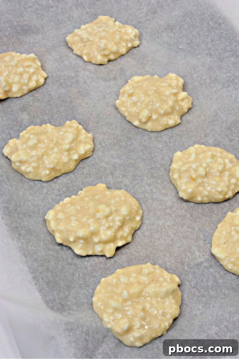 Dropping cottage cheese mixture onto parchment paper