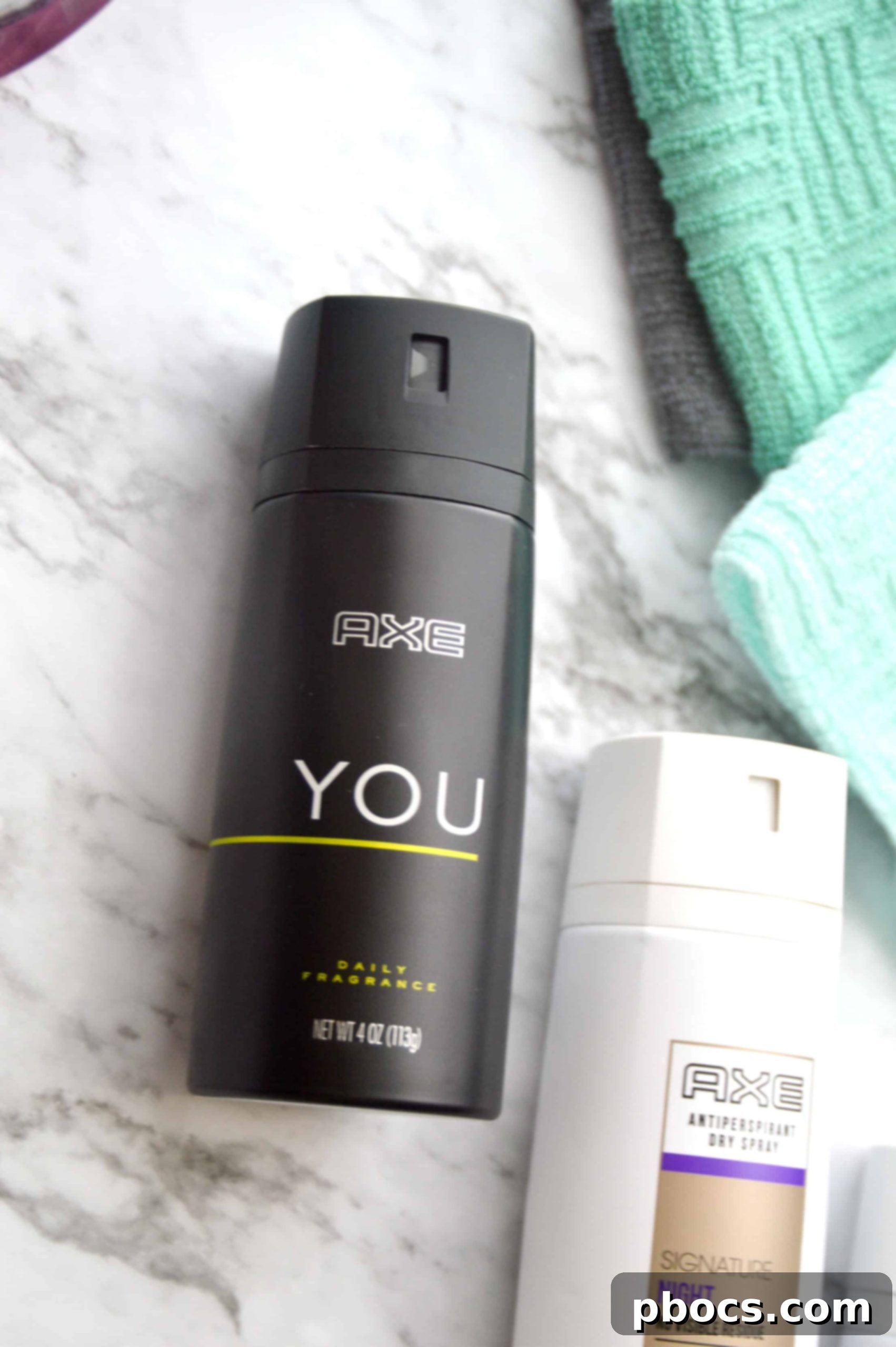 Five Easy Ways to Teach Your Teenager About Style and Grooming Close-up of AXE Dry Spray bottle, emphasizing essential grooming products for teens.