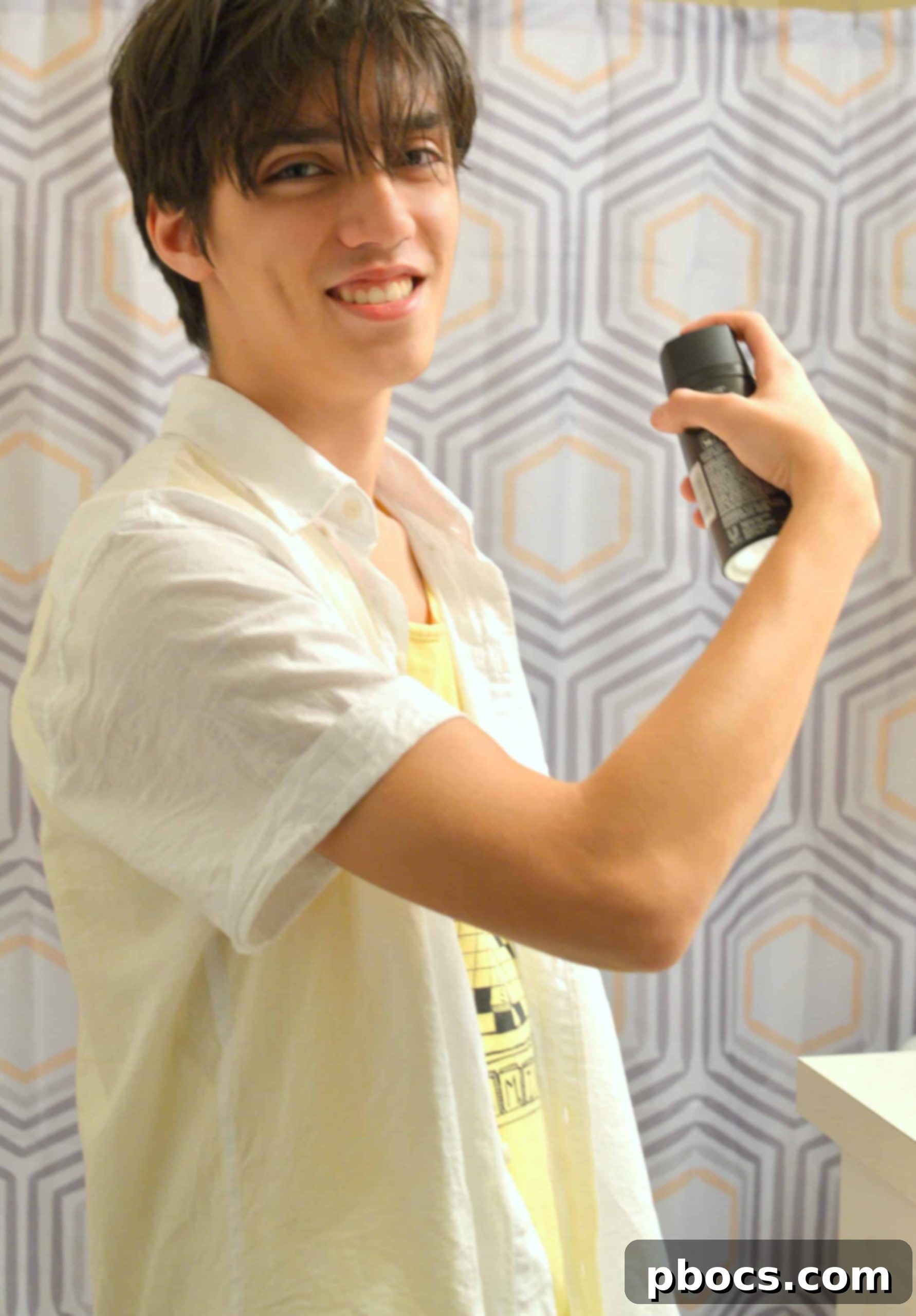 Five Easy Ways to Teach Your Teenager About Style and Grooming Teenager styling his hair, showcasing personal grooming and confidence.