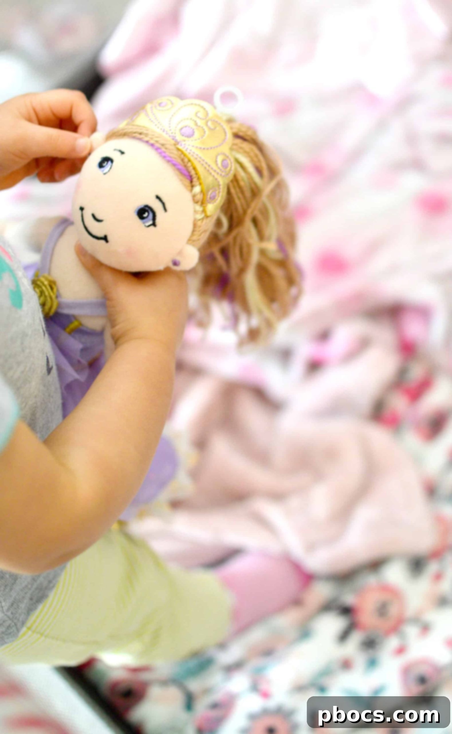Close-up of a child playing with a Baby Stella doll, demonstrating care.
