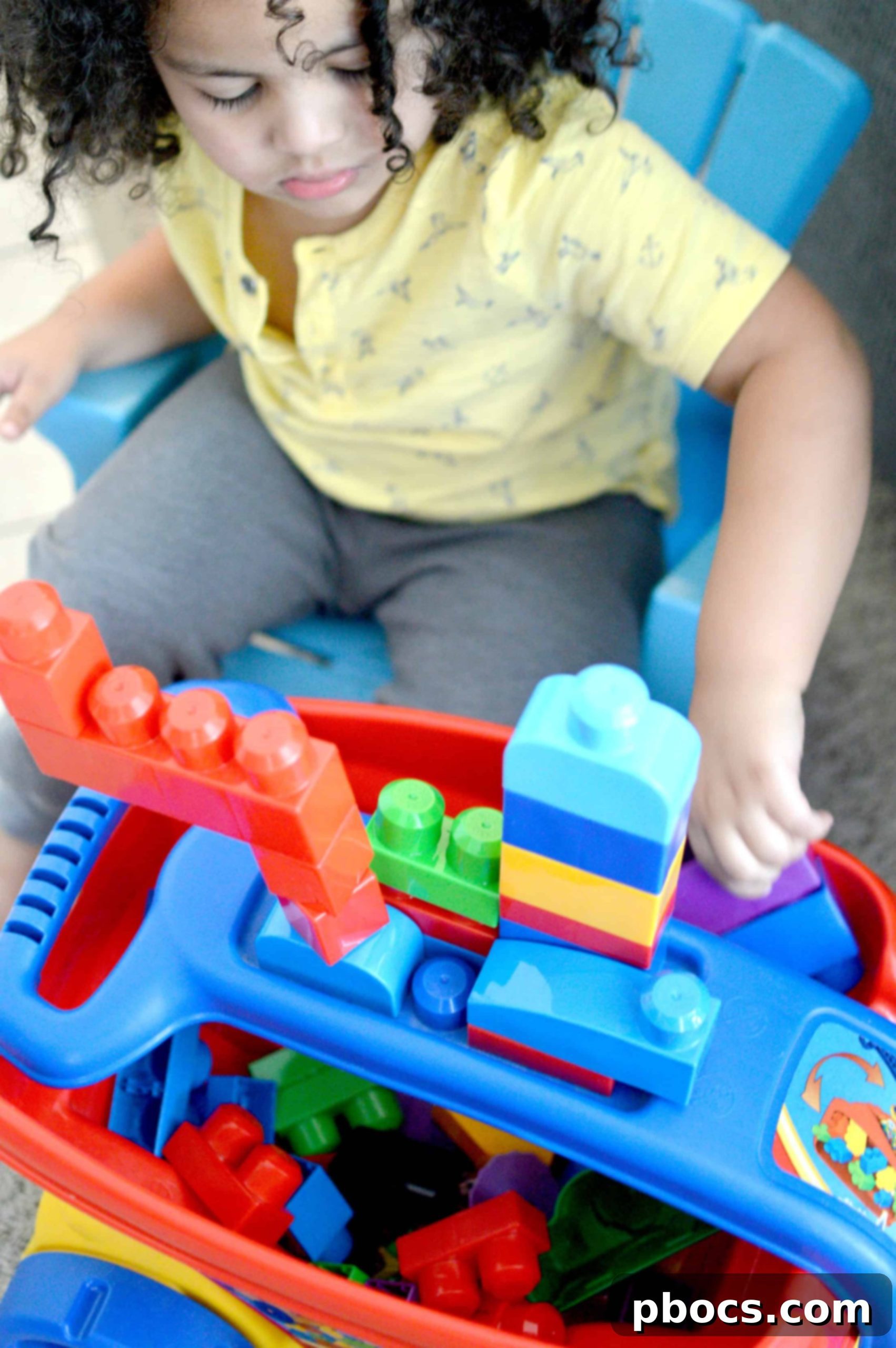 Two children playing an 'I-Spy' game together, pointing at objects and encouraging collaboration and communication.