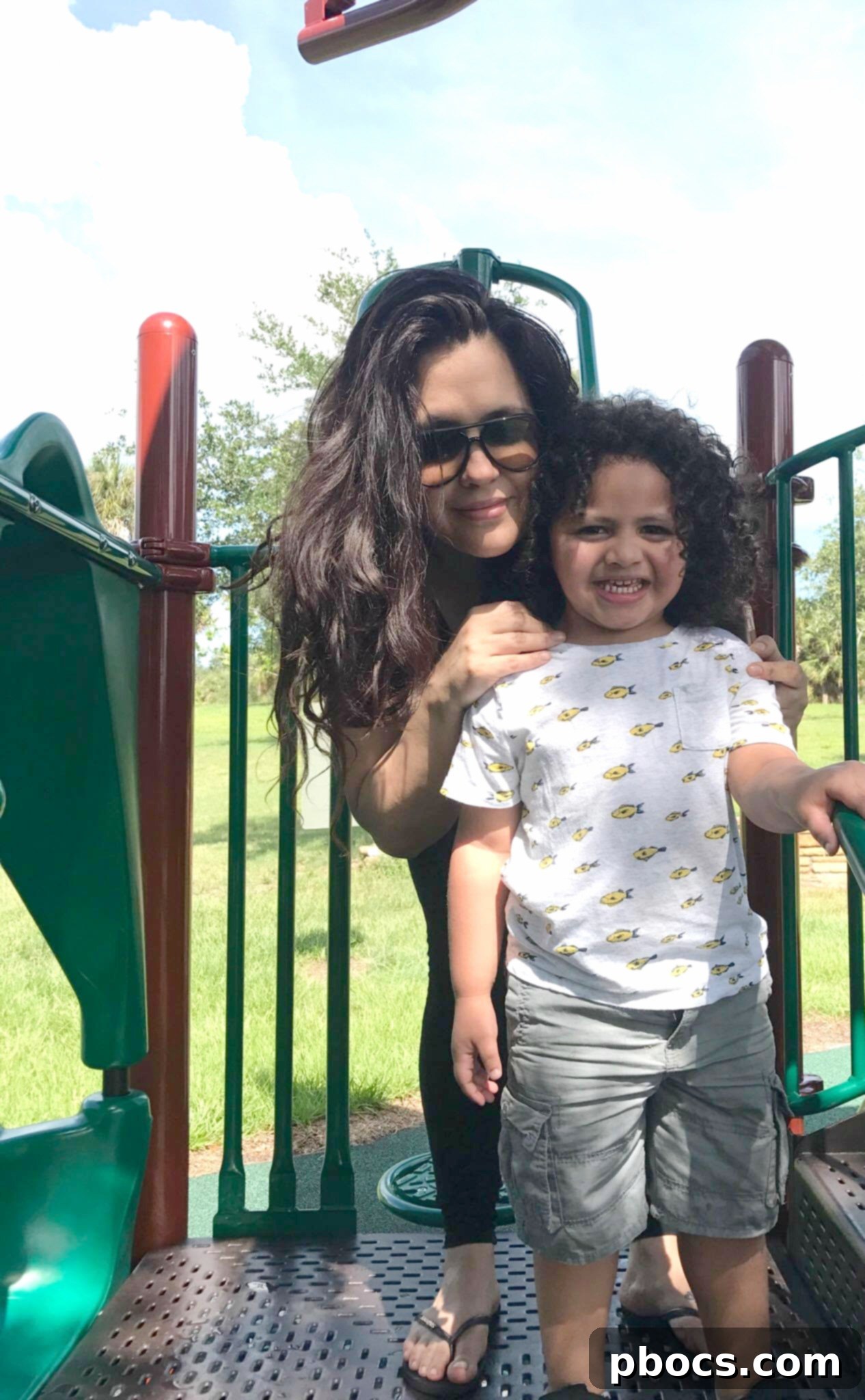 A child meticulously focused on building a structure with colorful wooden blocks, promoting creative problem-solving and focus.