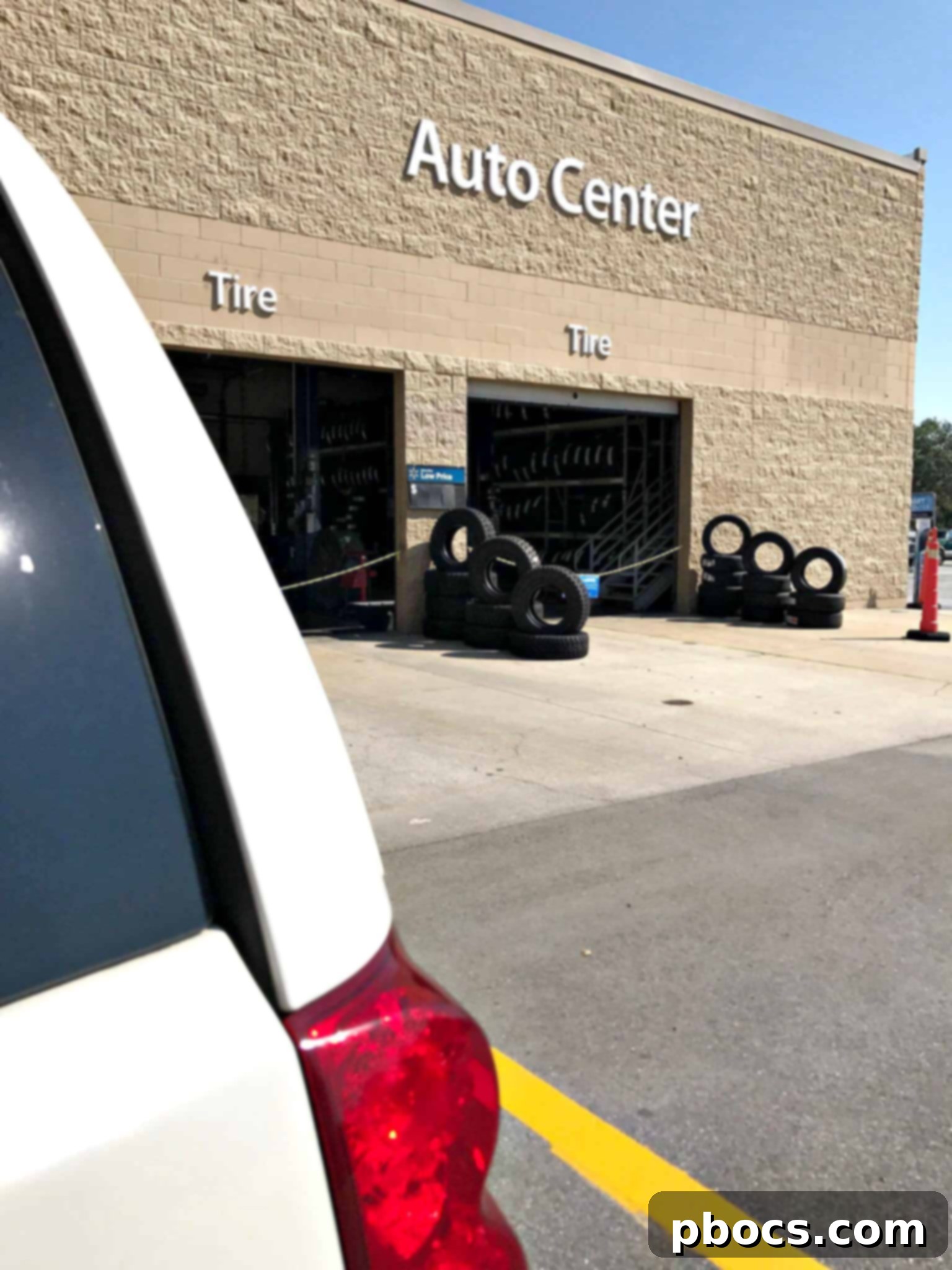 Quaker State motor oil products displayed on a shelf at Walmart Auto Center.