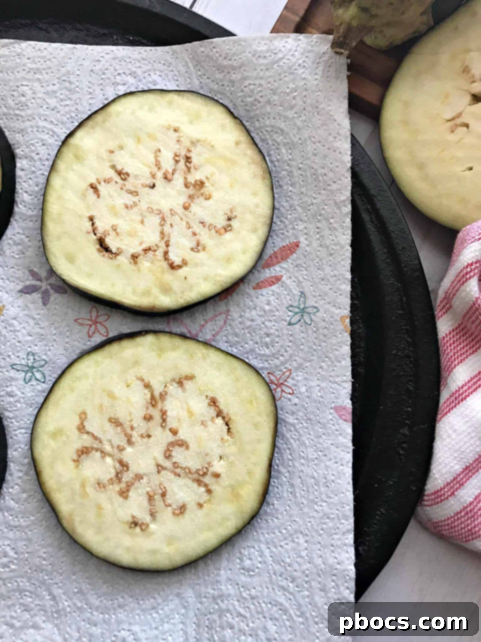 Eggplant slices sweating on paper towels