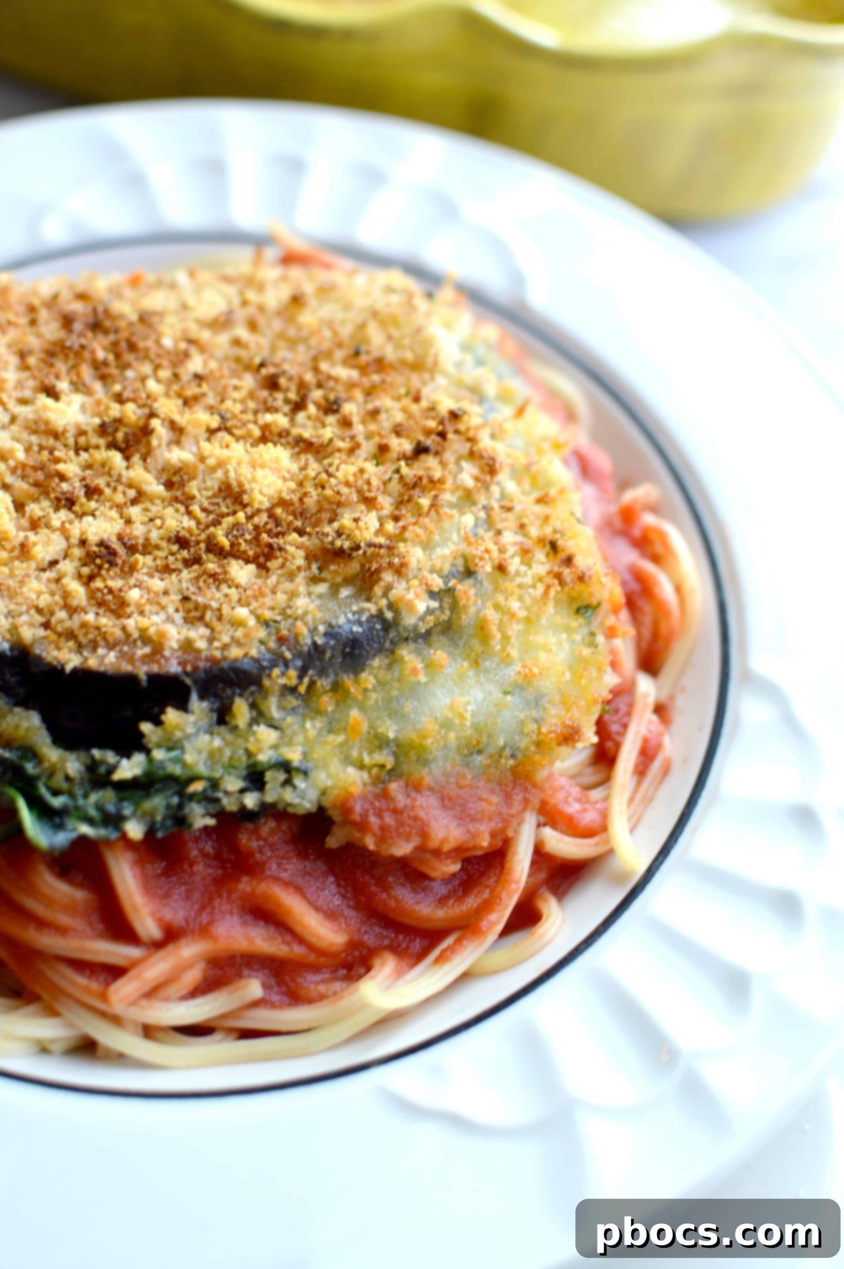 Plating Baked Eggplant and Spinach Parmesan with spaghetti