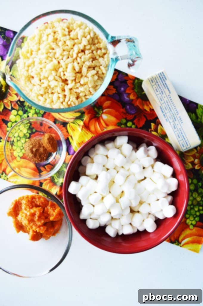 Close-up of freshly made pumpkin Rice Krispie treats in a pan, ready to be cut.