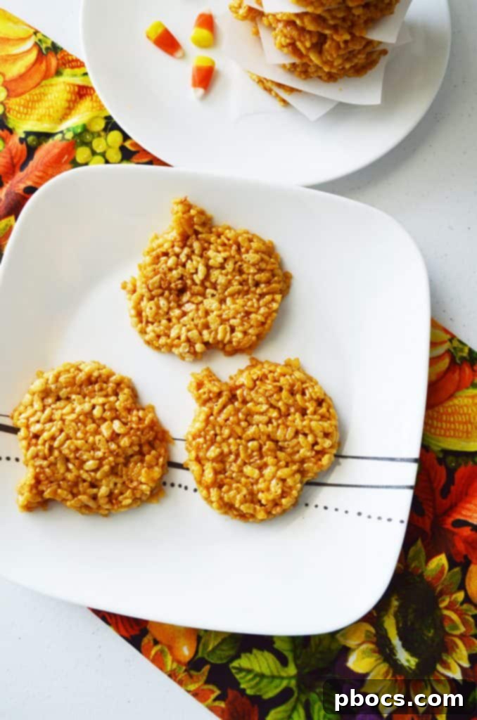 Variety of pumpkin-shaped Rice Krispie treats displayed on a festive autumn background.